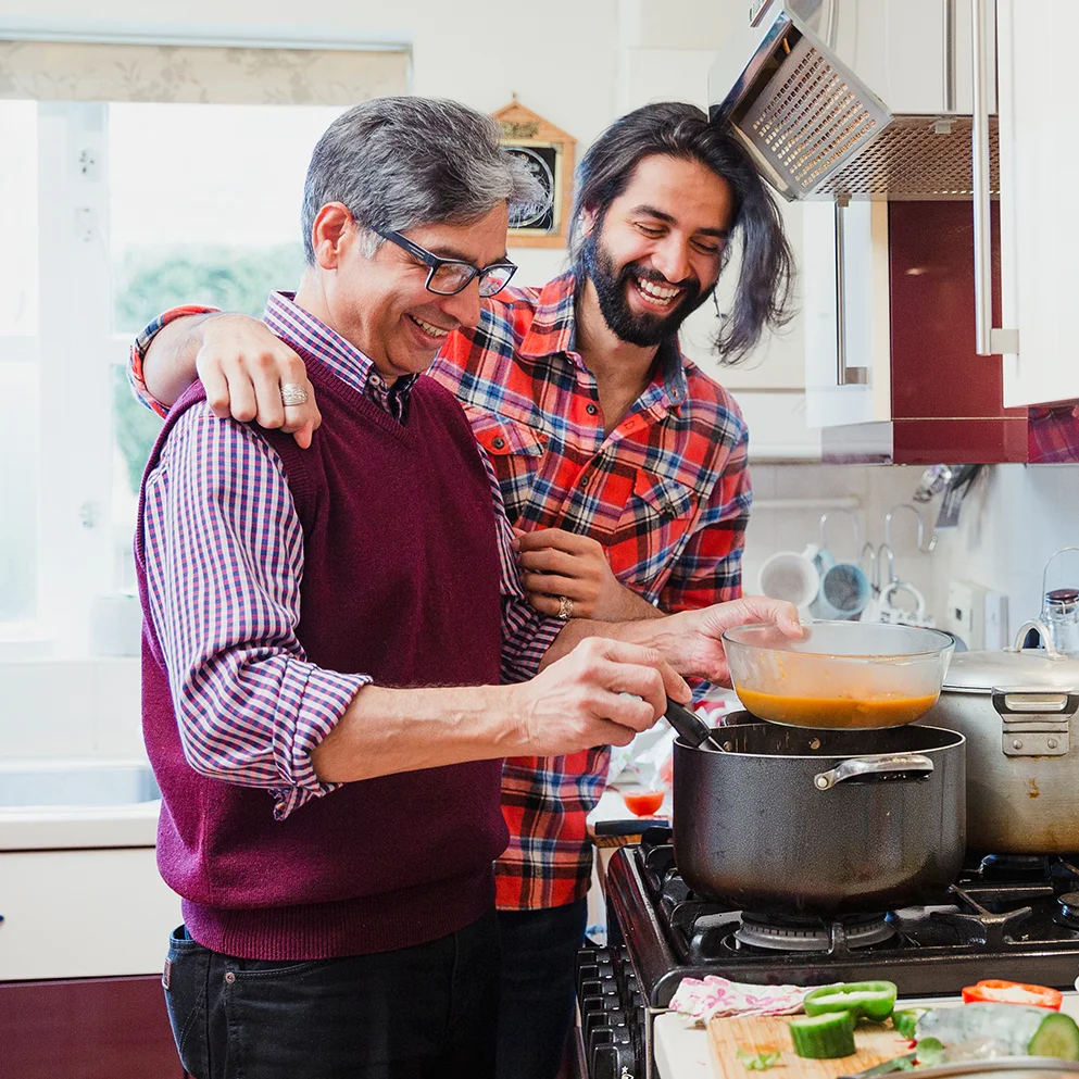 Smiling man and father in kitchen cooking