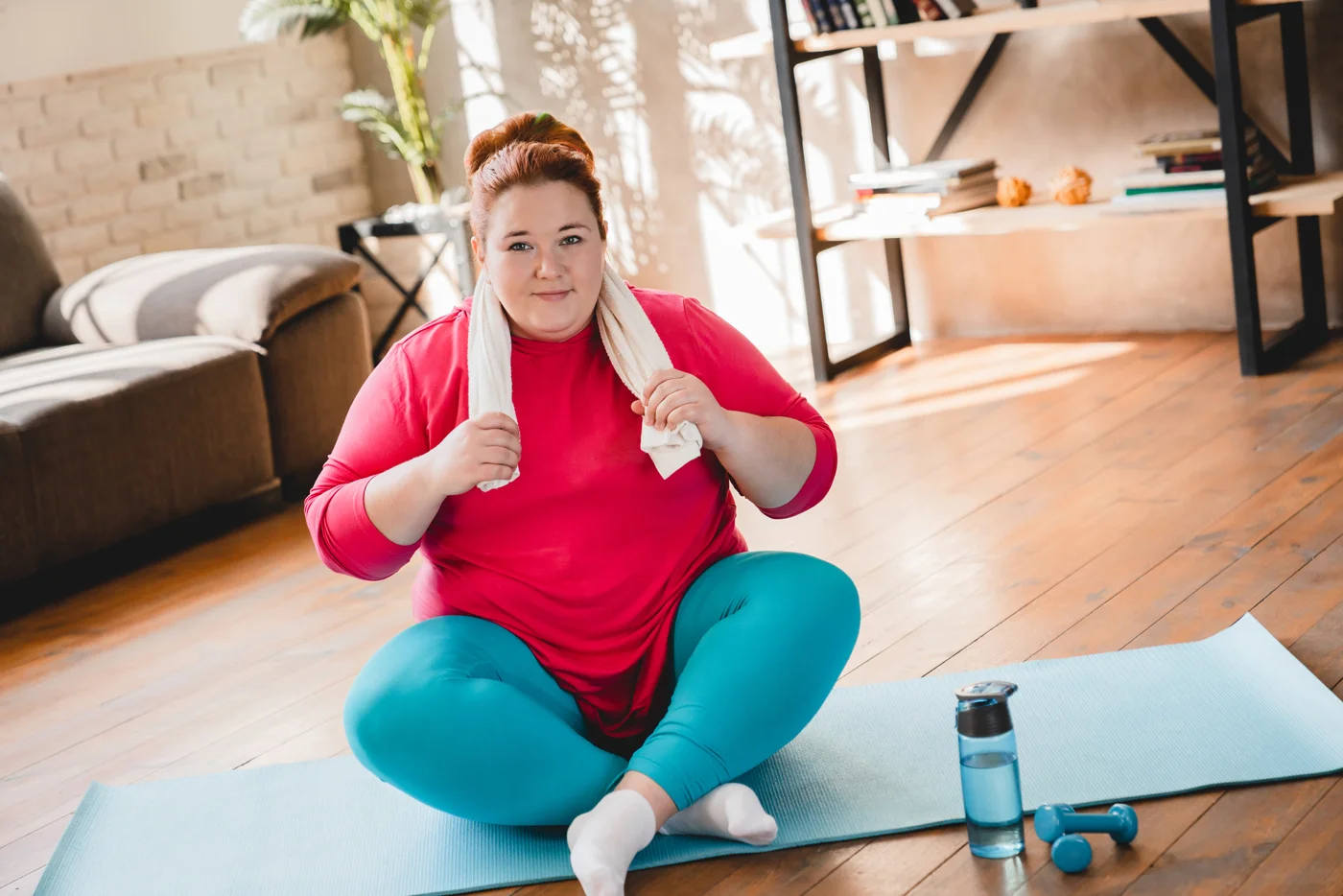 Woman dieting, fitness and healthy food at home. Plus size fat woman tired after workout at home for losing weight and healthy lifestyle, fat burning exercises