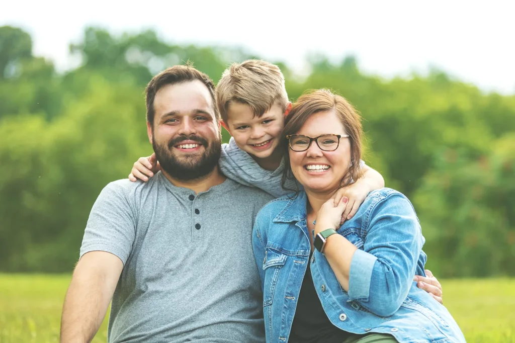 Smiling family outside