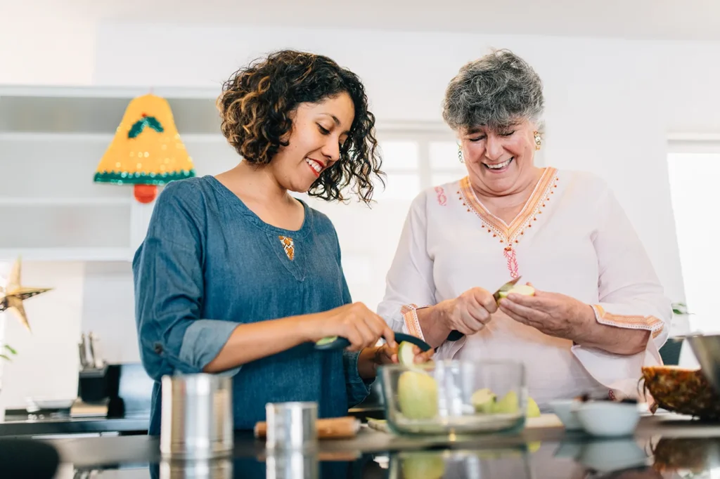 Woman and her mother cooking together