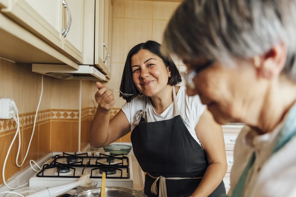 Woman and mother cooking together