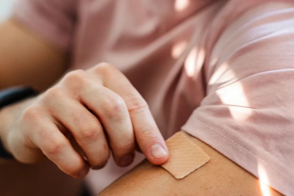 Applying nicotine patch to arm