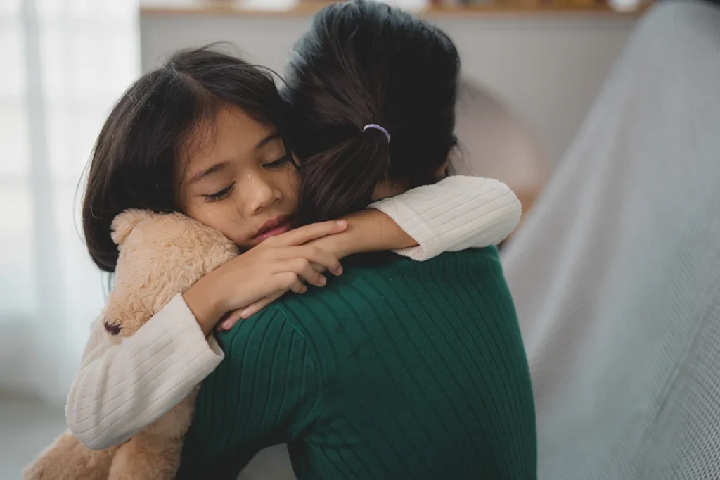 Mother embracing sad child