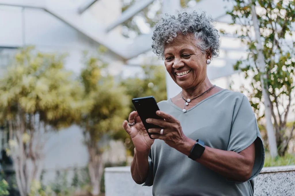 Smiling older lady looking at phone