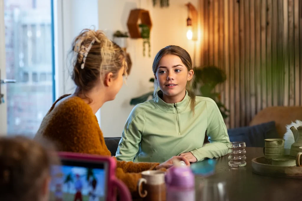 Mother and teen daughter talking