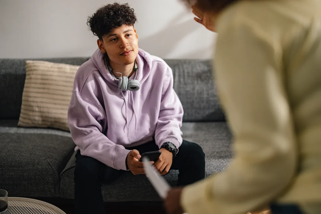 Woman talking to teen boy