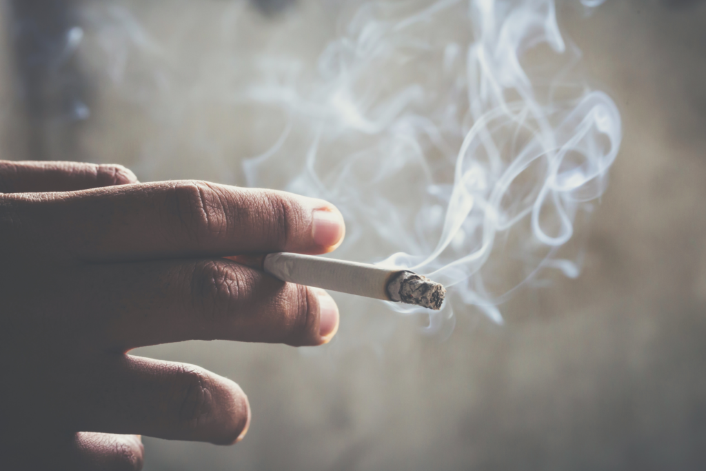 A hand holding a cigarette.