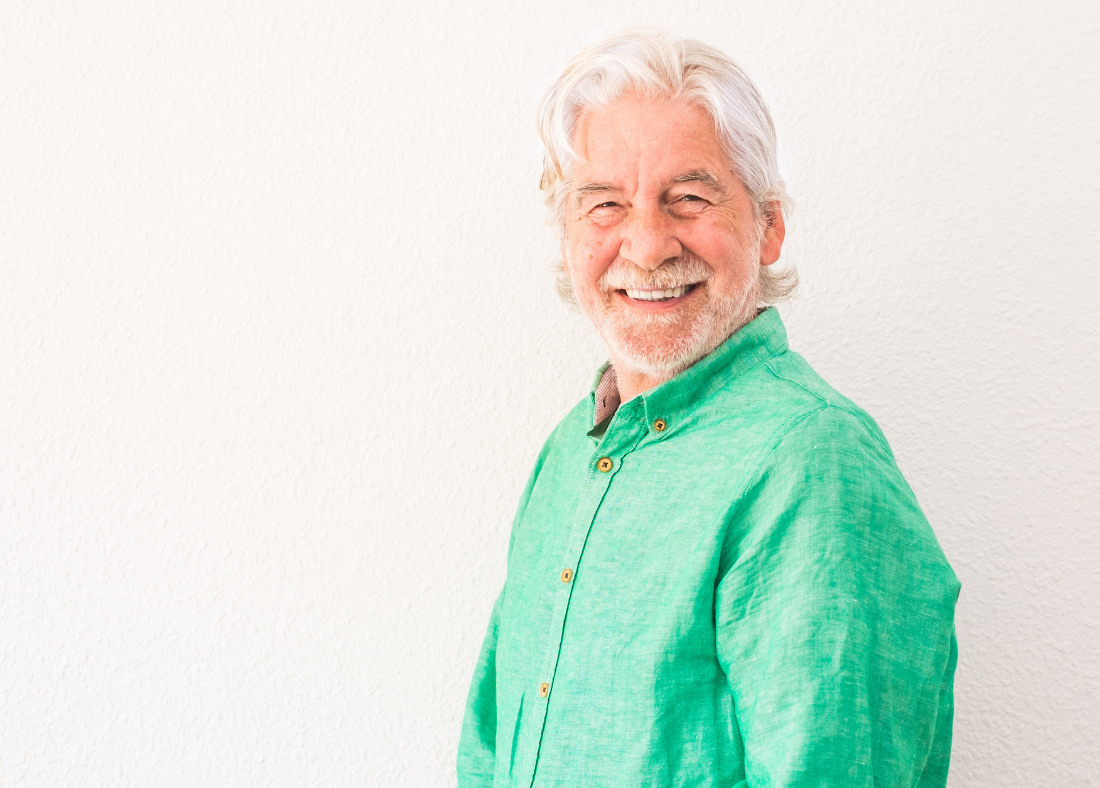 An image of a 60 year old man, smiling to camera.