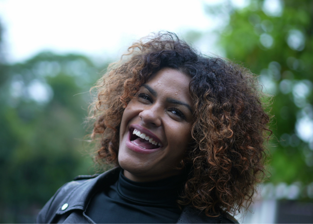 A women standing in the park, smiling