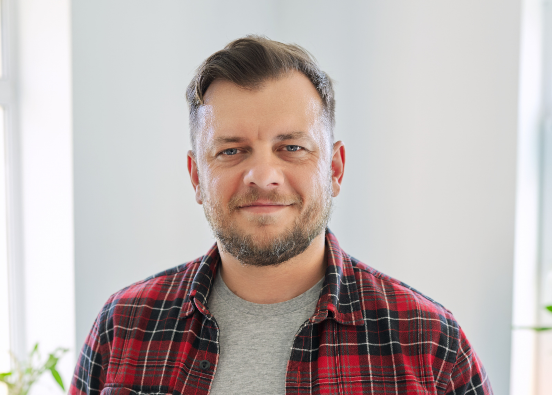 An image of a 45 year old man, smiling to camera.